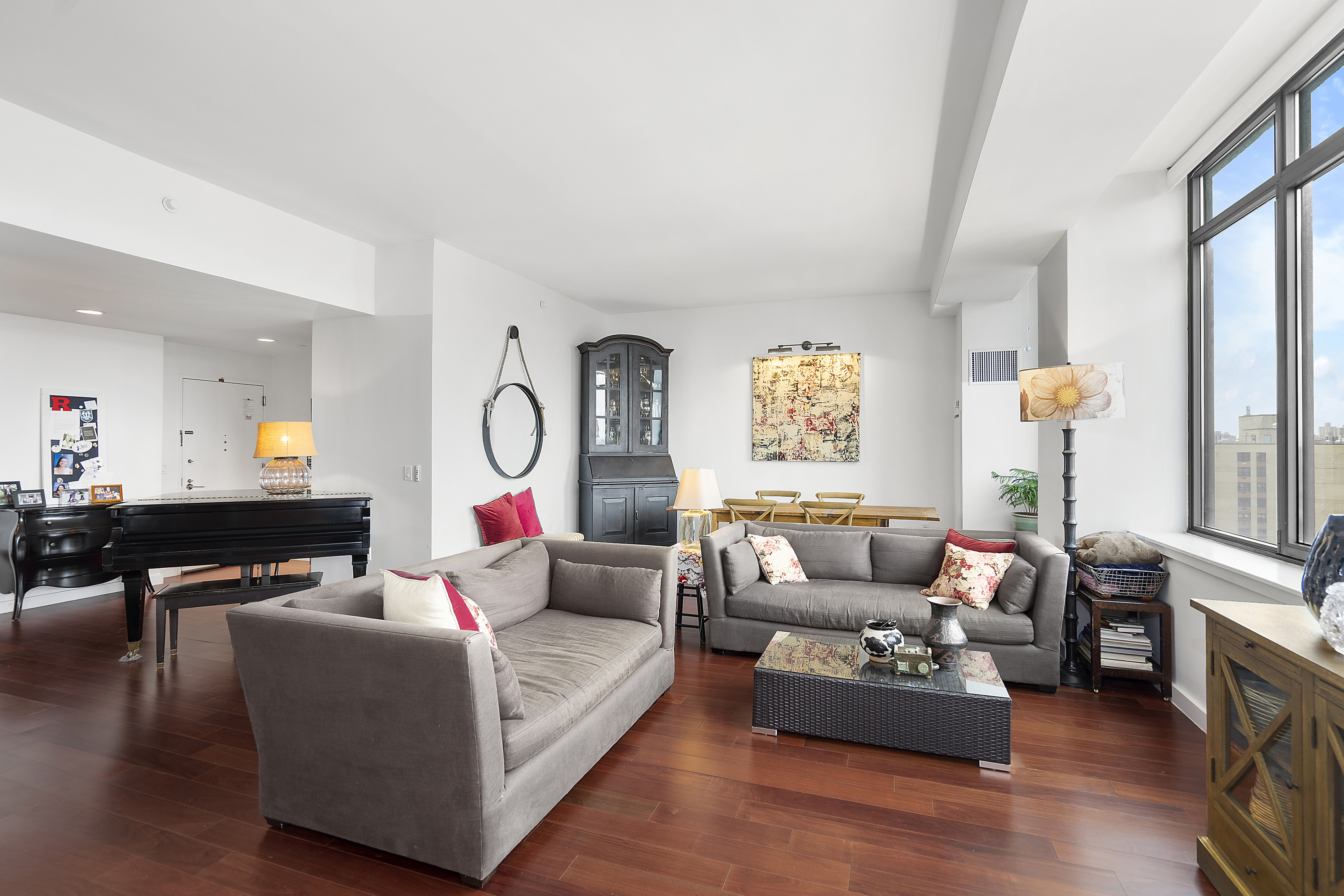 1485 5th Avenue, Unit 18/19H Manhattan, NY 10035 - Photo 5 of 21 a living room with furniture and a floor to ceiling window