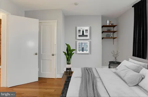 a living room with furniture rug and wall paintings