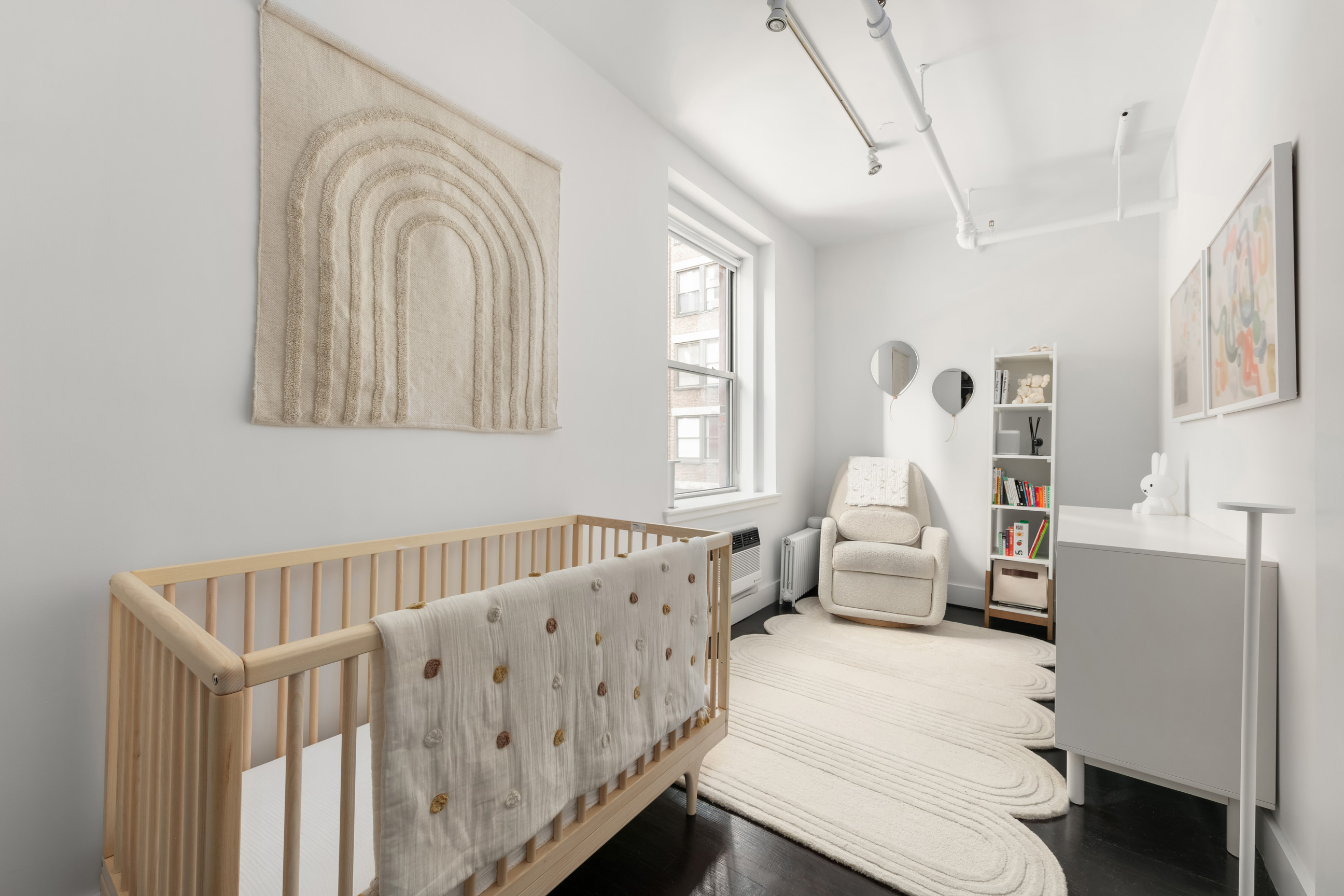 133-131 West 28th Street, Unit 6C Manhattan, NY 10001 - Photo 8 of 10 a living room with furniture and a window