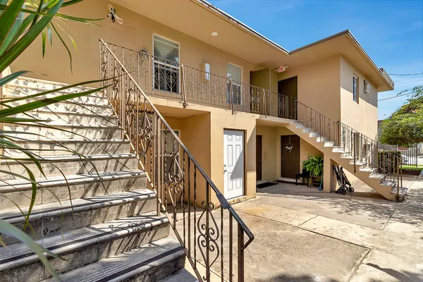 a view of a house with a wooden fence