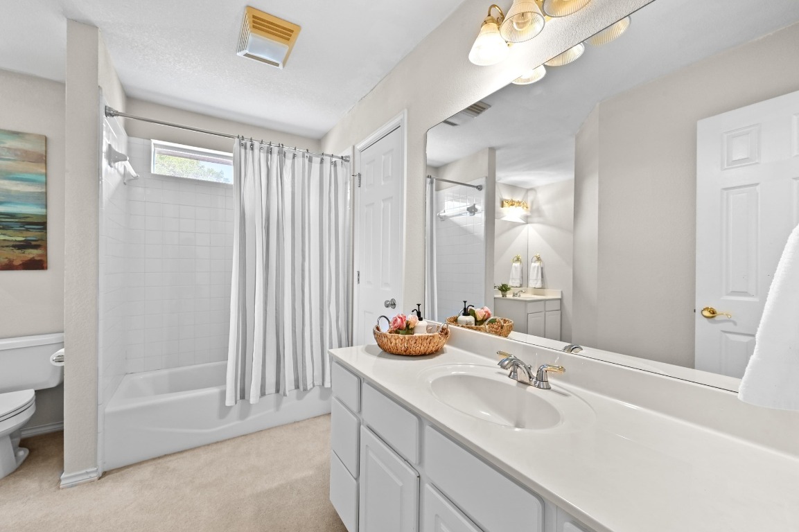 111 Trinity Street Cedar Creek, TX 78612 - Photo 24 of 38 a bathroom with 2 sink tub and a mirror