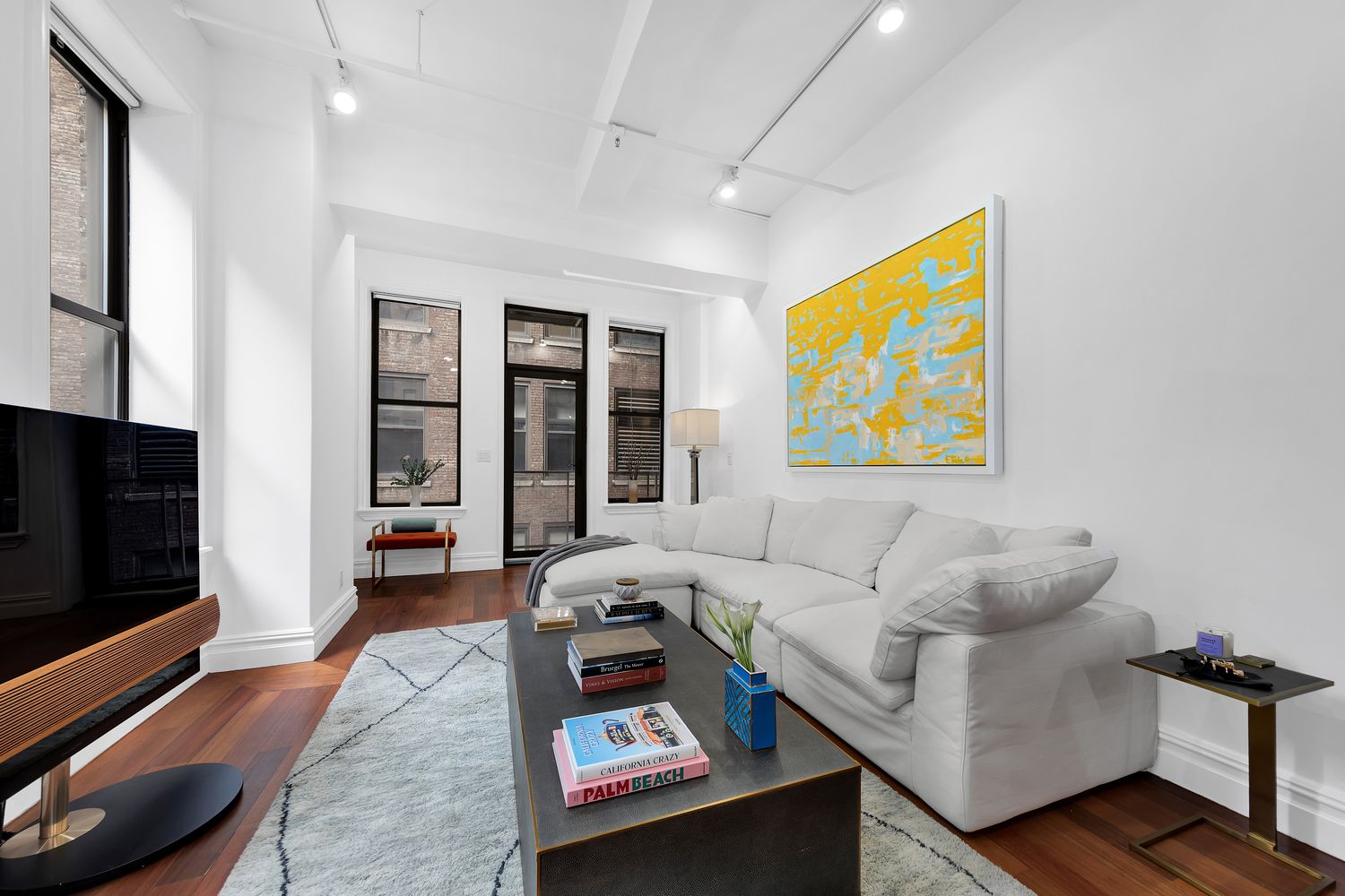 a living room with furniture and a flat screen tv