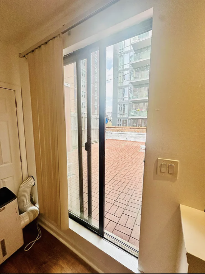 305 East 95th Street, Unit 6E Manhattan, NY 10128 - Photo 5 of 9 a view of a room with wooden floor and windows