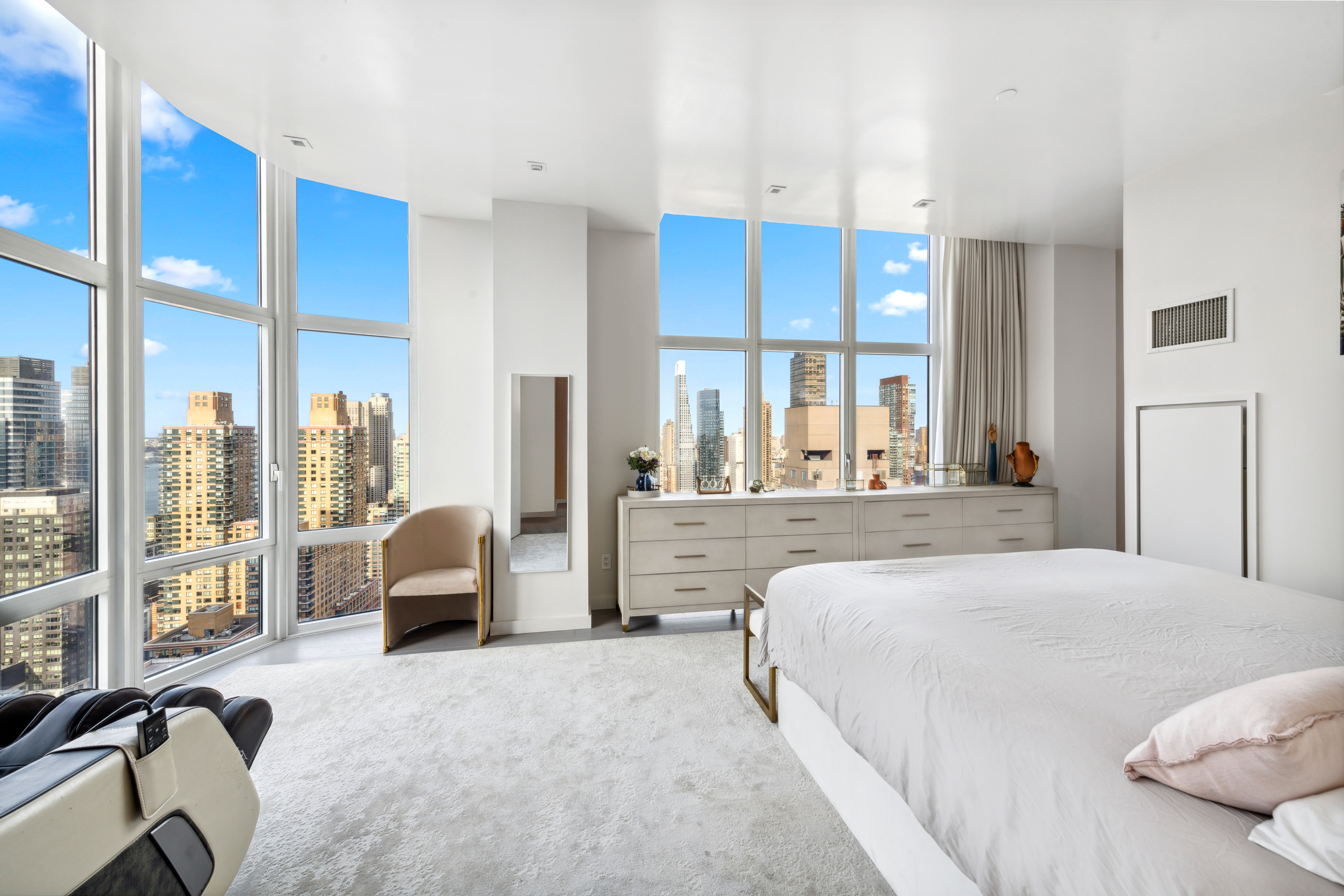 555 West 59th Street, Unit PHA Manhattan, NY 10019 - Photo 7 of 20 a large bedroom with a large bed and windows