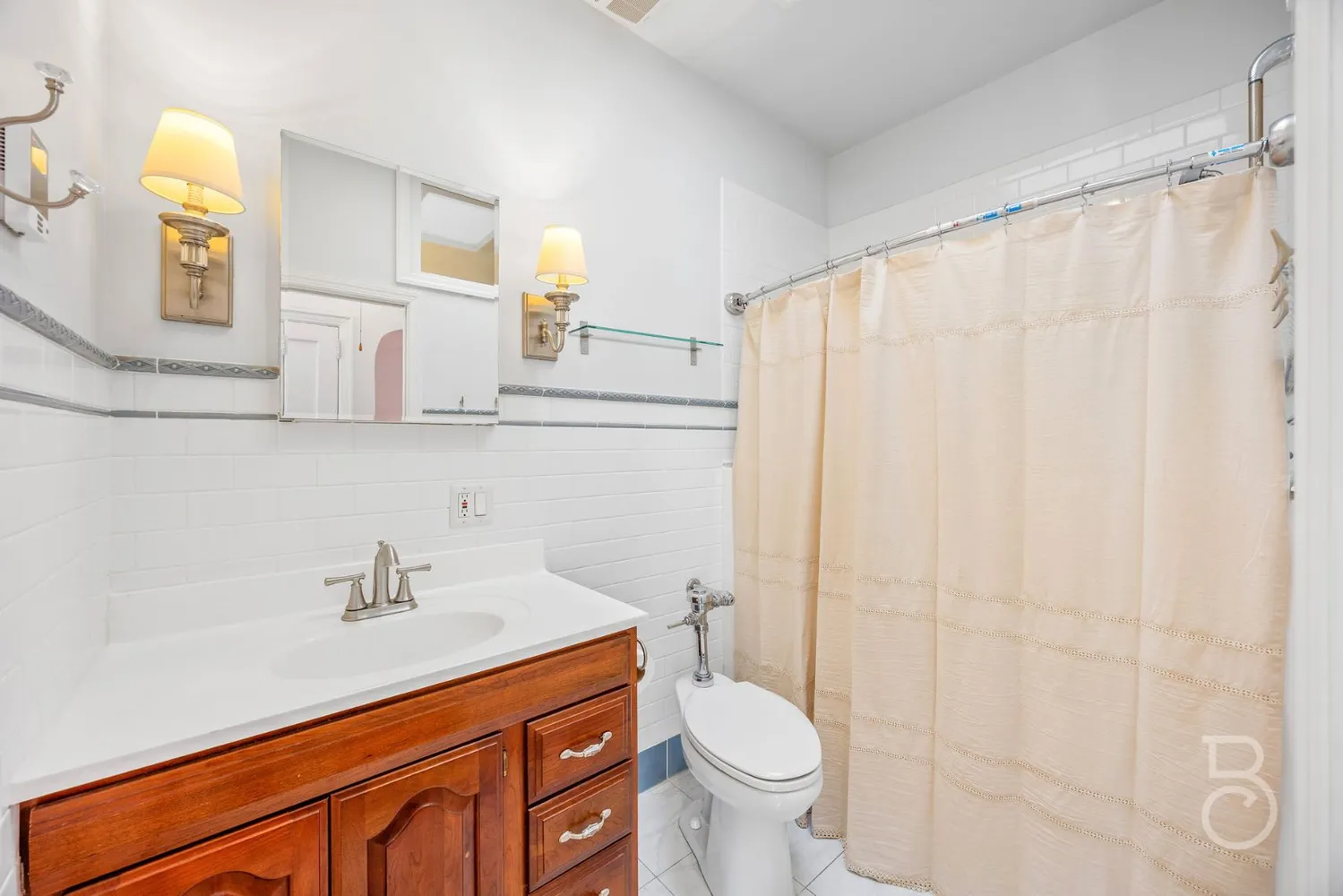 a bathroom with a sink a toilet and shower curtain