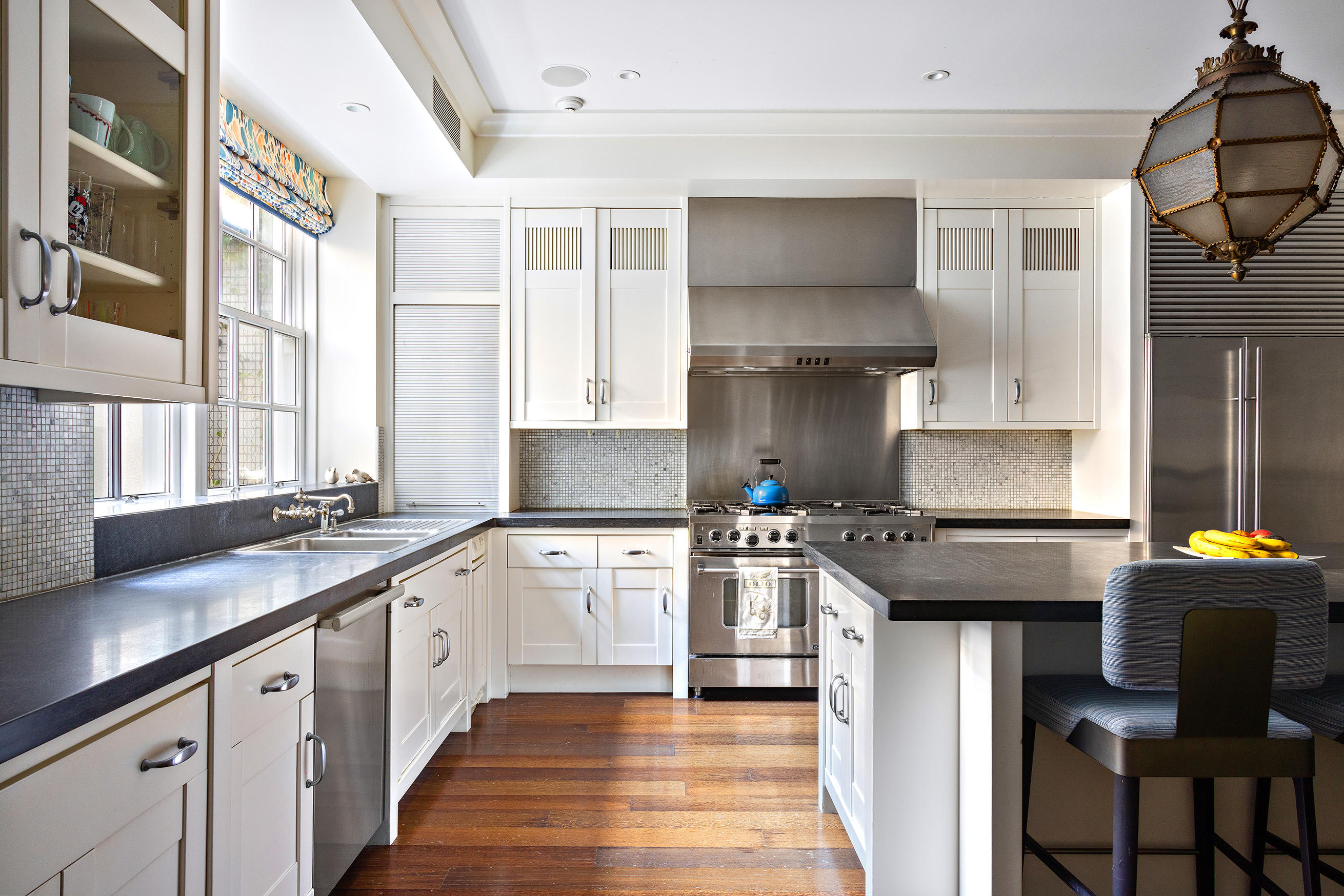 127 East 73rd Street Manhattan, NY 10021 - Photo 22 of 40 a kitchen with stainless steel appliances granite countertop a stove and a sink
