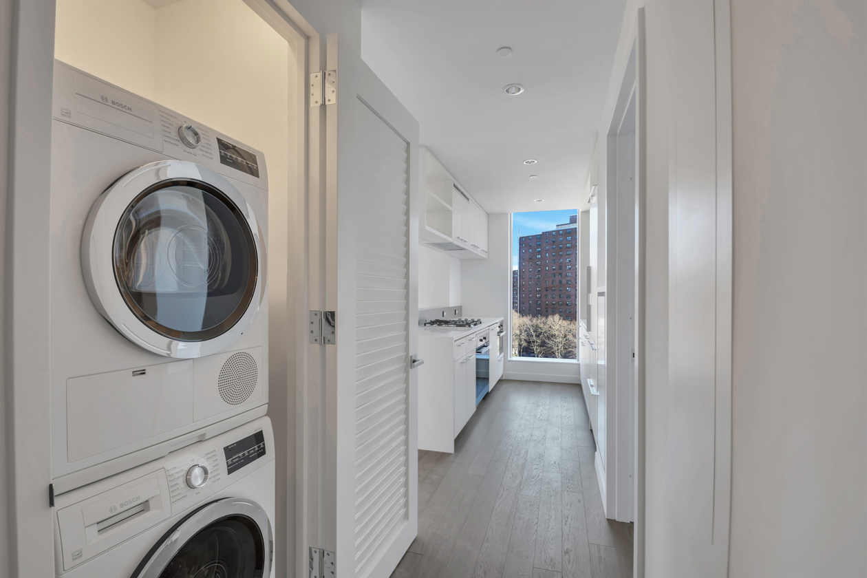 252 South Street, Unit 10K Manhattan, NY 10002 - Photo 5 of 19 a view of a hallway with washer and dryer
