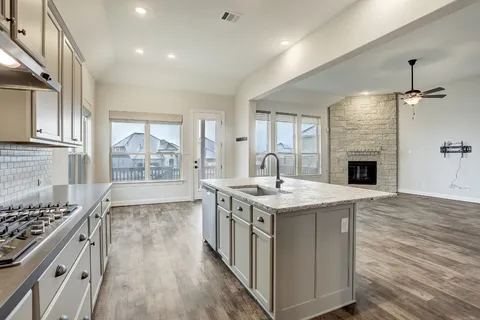 a kitchen with a stove and a sink