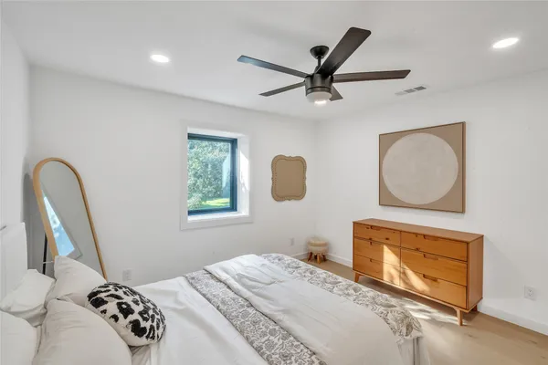 a bedroom with a bed and a window