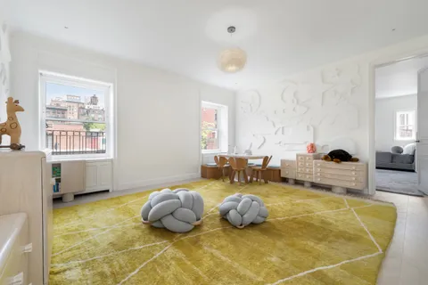 a bedroom with furniture and a window