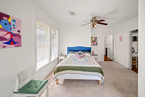 a bedroom with a bed and a window