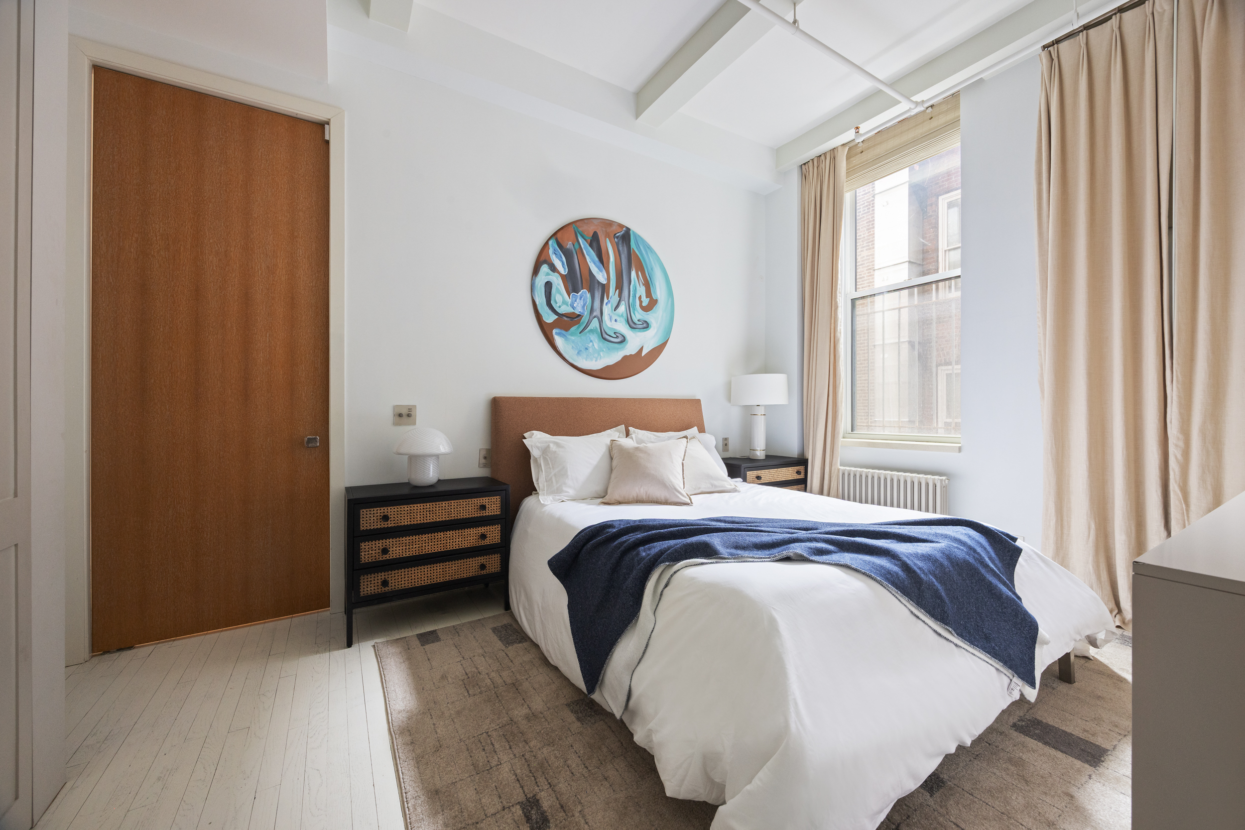 32 West 20th Street, Unit 5 Manhattan, NY 10011 - Photo 13 of 18 a bed sitting in a bedroom next to a window