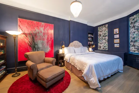 a bedroom with bed and window