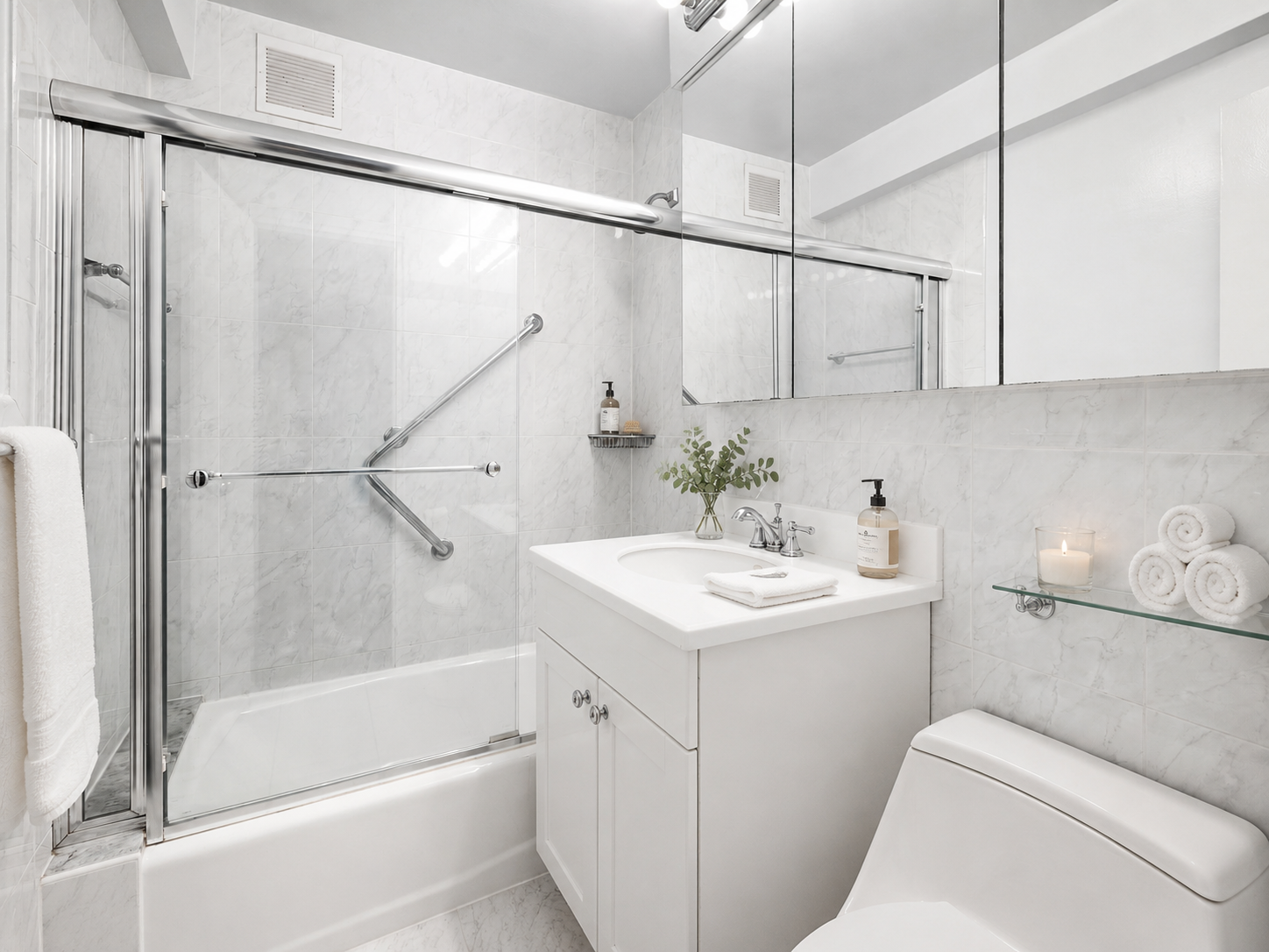 420 East 72nd Street, Unit 7L Manhattan, NY 10021 - Photo 7 of 10 a bathroom with a sink and mirror with bathtub