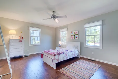 a bedroom with a bed and a desk