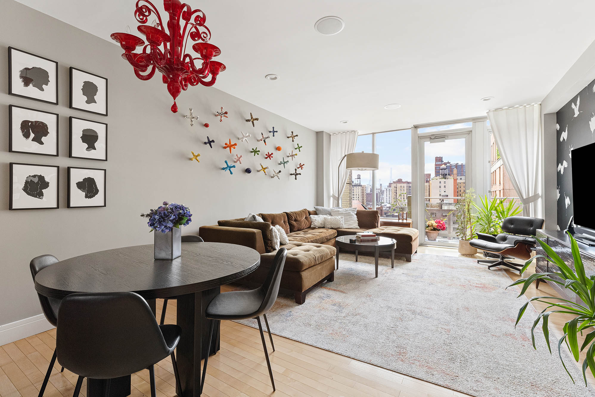545 West 110th Street, Unit PH11A Manhattan, NY 10025 - Photo 7 of 22 a living room with furniture a chandelier and a flat screen tv