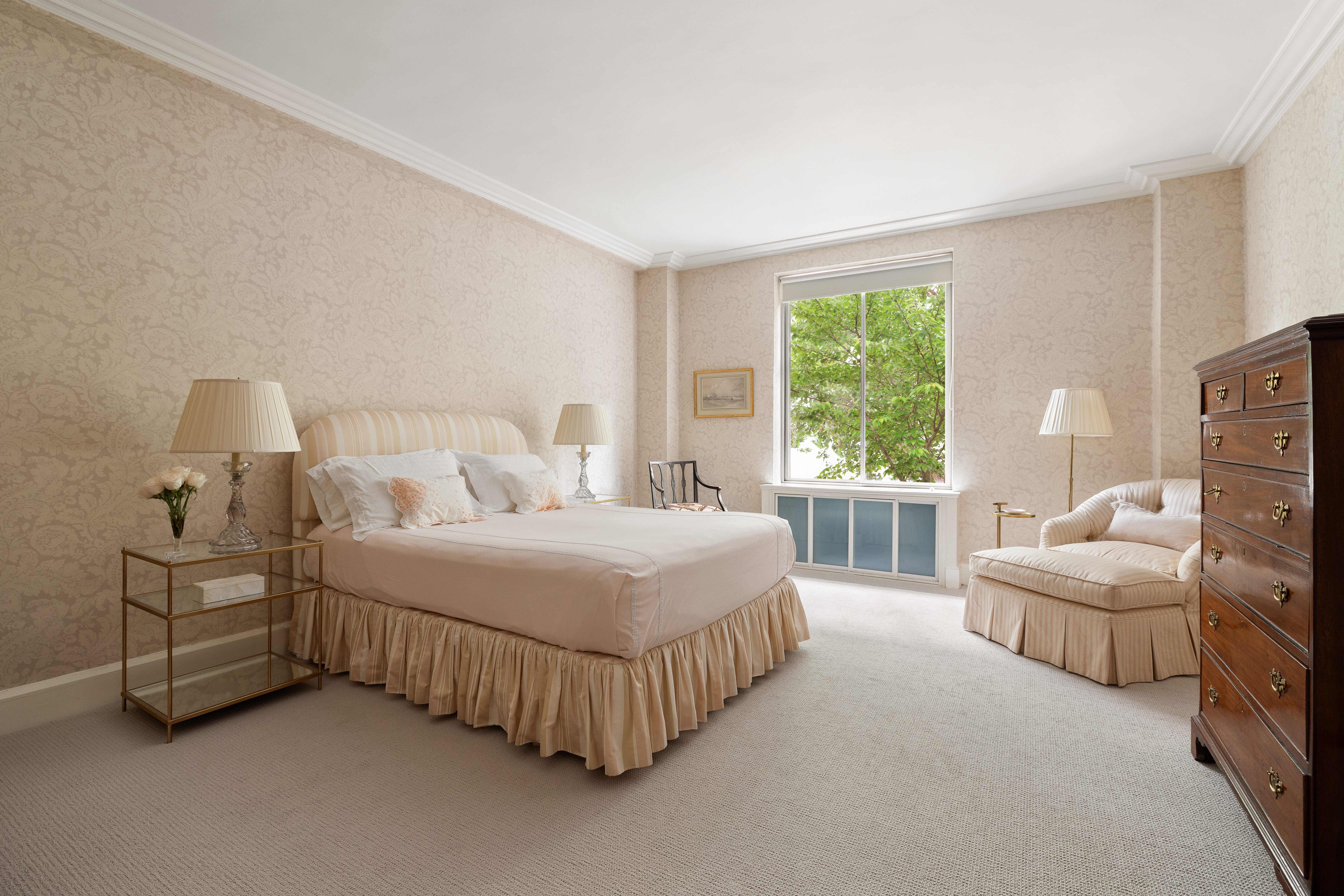 116 East 68th Street, Unit 2D Manhattan, NY 10065 - Photo 8 of 12 a bedroom with bed and white walls with couch