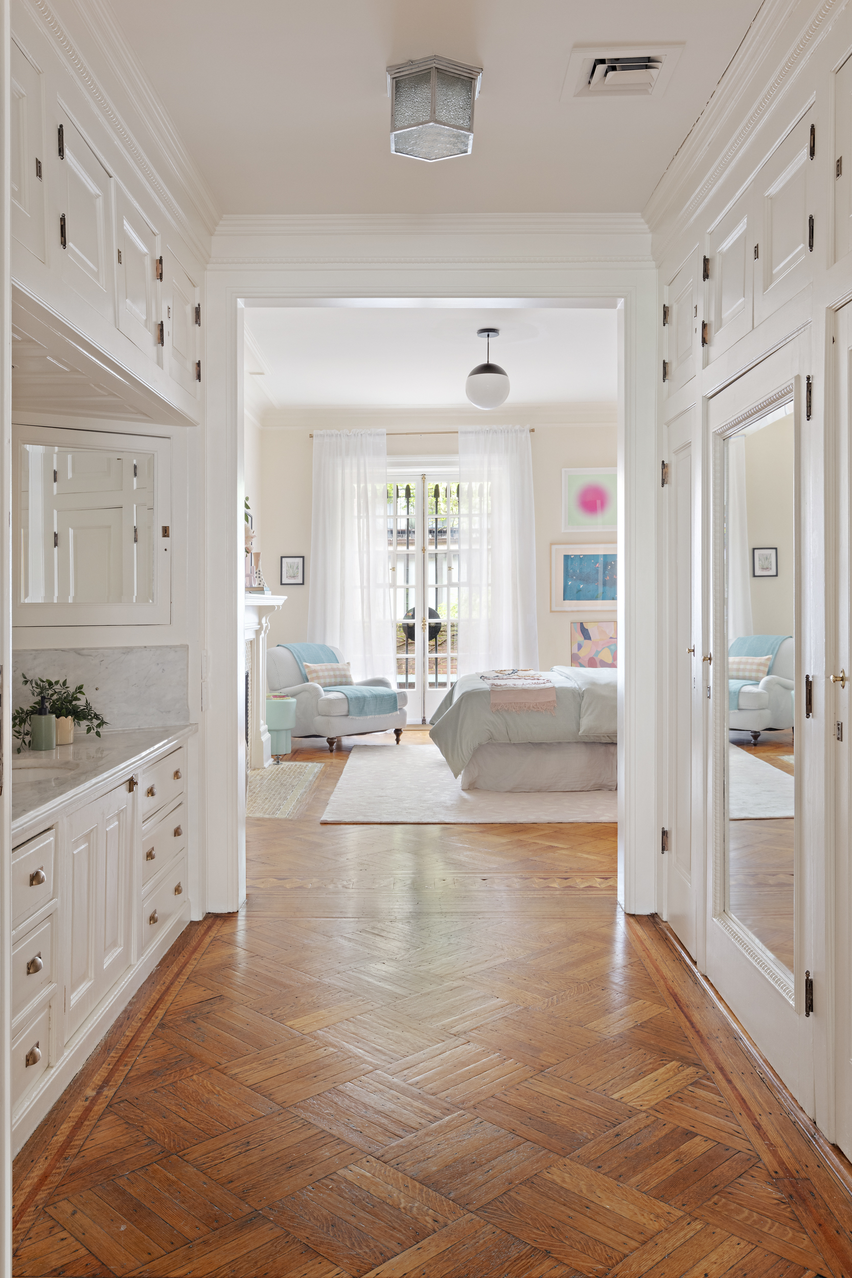 37 West 70th Street Manhattan, NY 10023 - Photo 27 of 41 a large white kitchen with cabinets a sink and a refrigerator