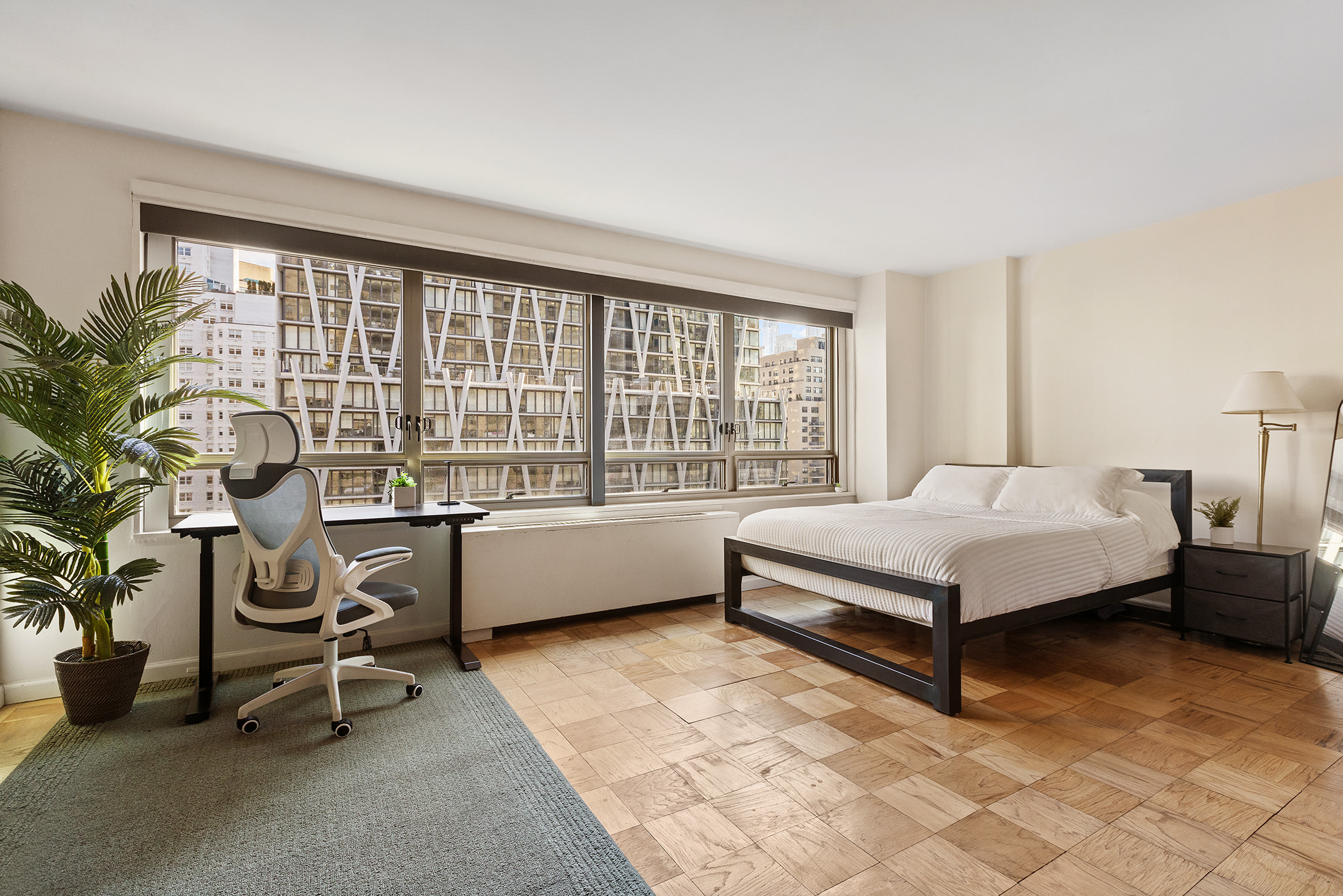 170 West End Avenue, Unit 12C Manhattan, NY 10023 - Photo 2 of 9 a spacious bedroom with a bed and a table in it