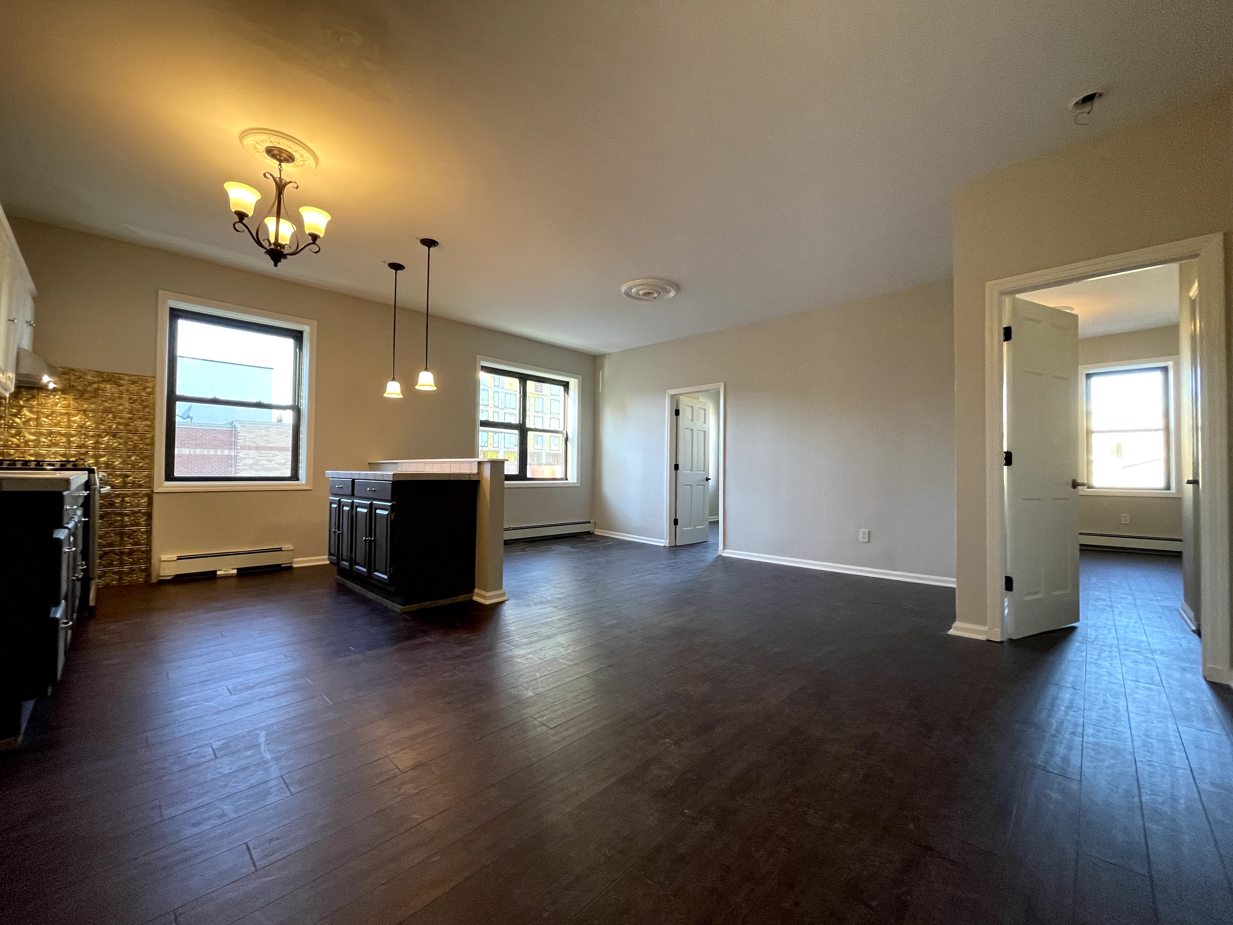 350 Irving Avenue, Unit 2F Brooklyn, NY 11237 - Photo 2 of 5 a view of a livingroom with hardwood floor and a ceiling fan