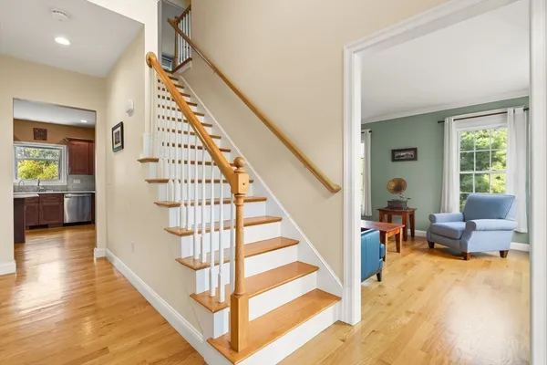 a view of entryway and hall with wooden floor