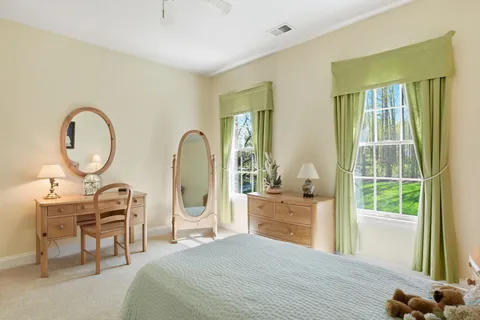 a spacious bathroom with a tub sink shower and mirror