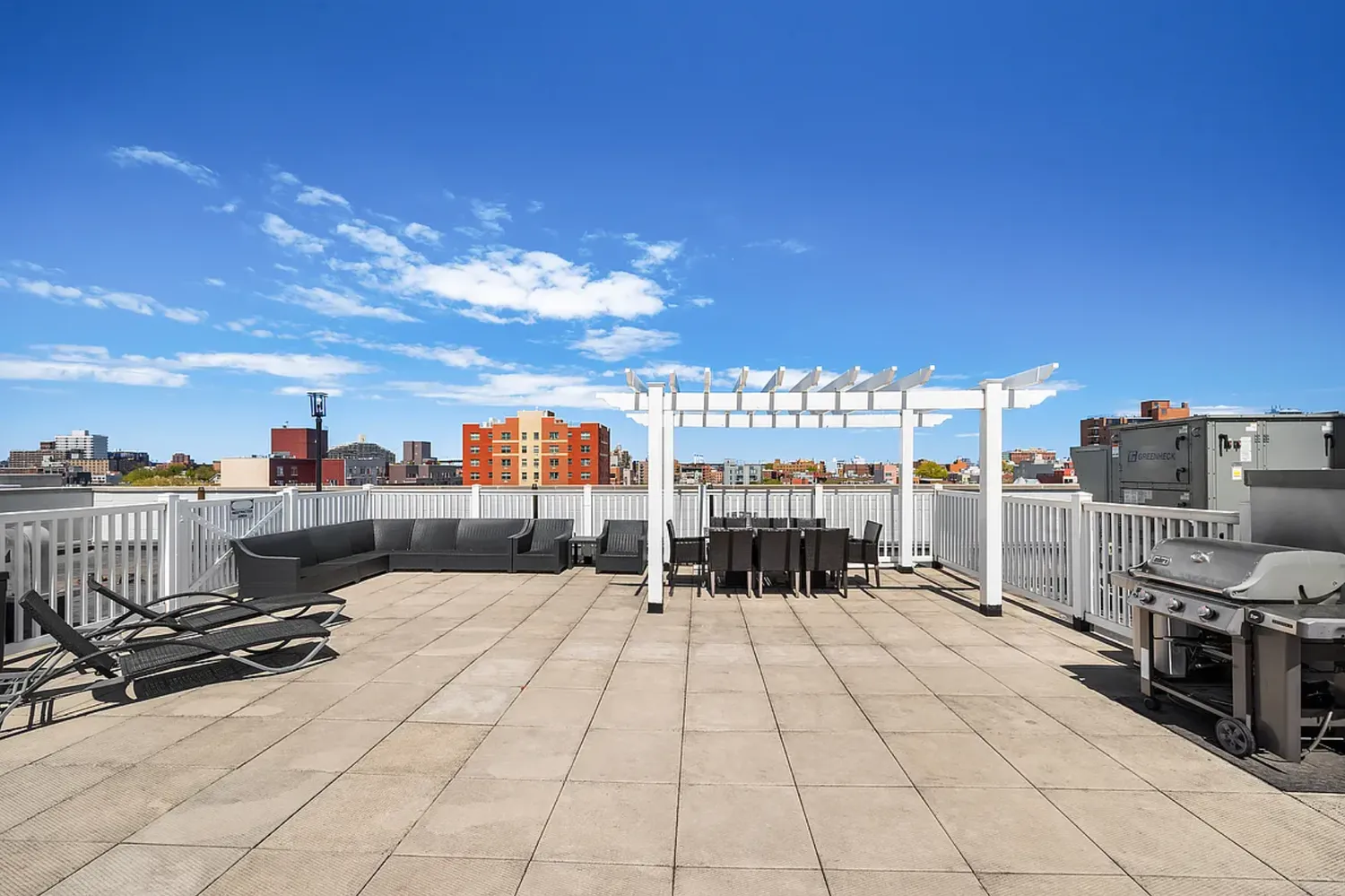 a view of roof deck with dining table and chairs