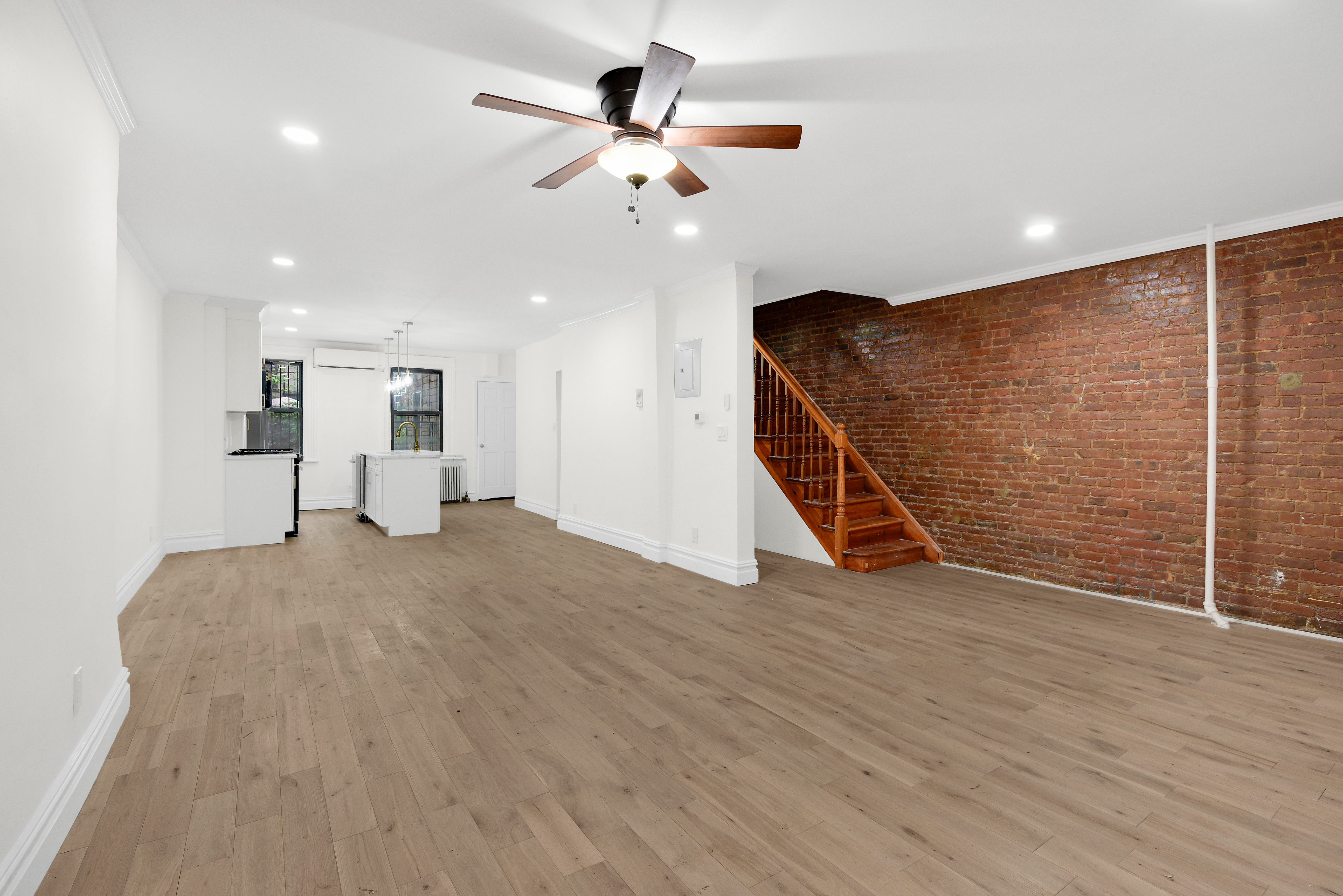 615 Willoughby Avenue, Unit 1 Brooklyn, NY 11206 - Photo 4 of 13 a view of an empty room with wooden floor and a ceiling fan
