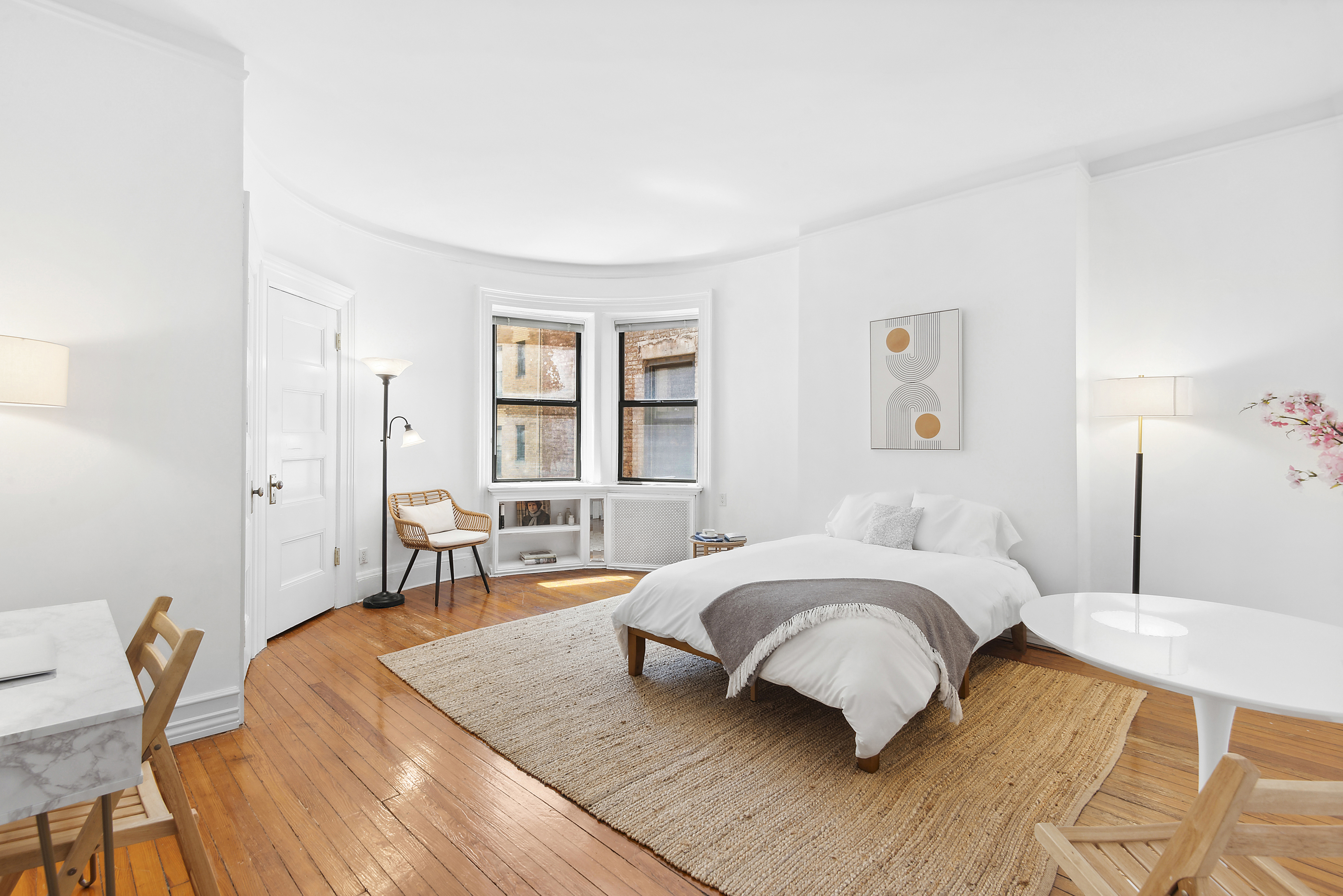 293 Riverside Drive, Unit 5B Manhattan, NY 10025 - Photo 1 of 9 a bedroom with a bed a table and chair