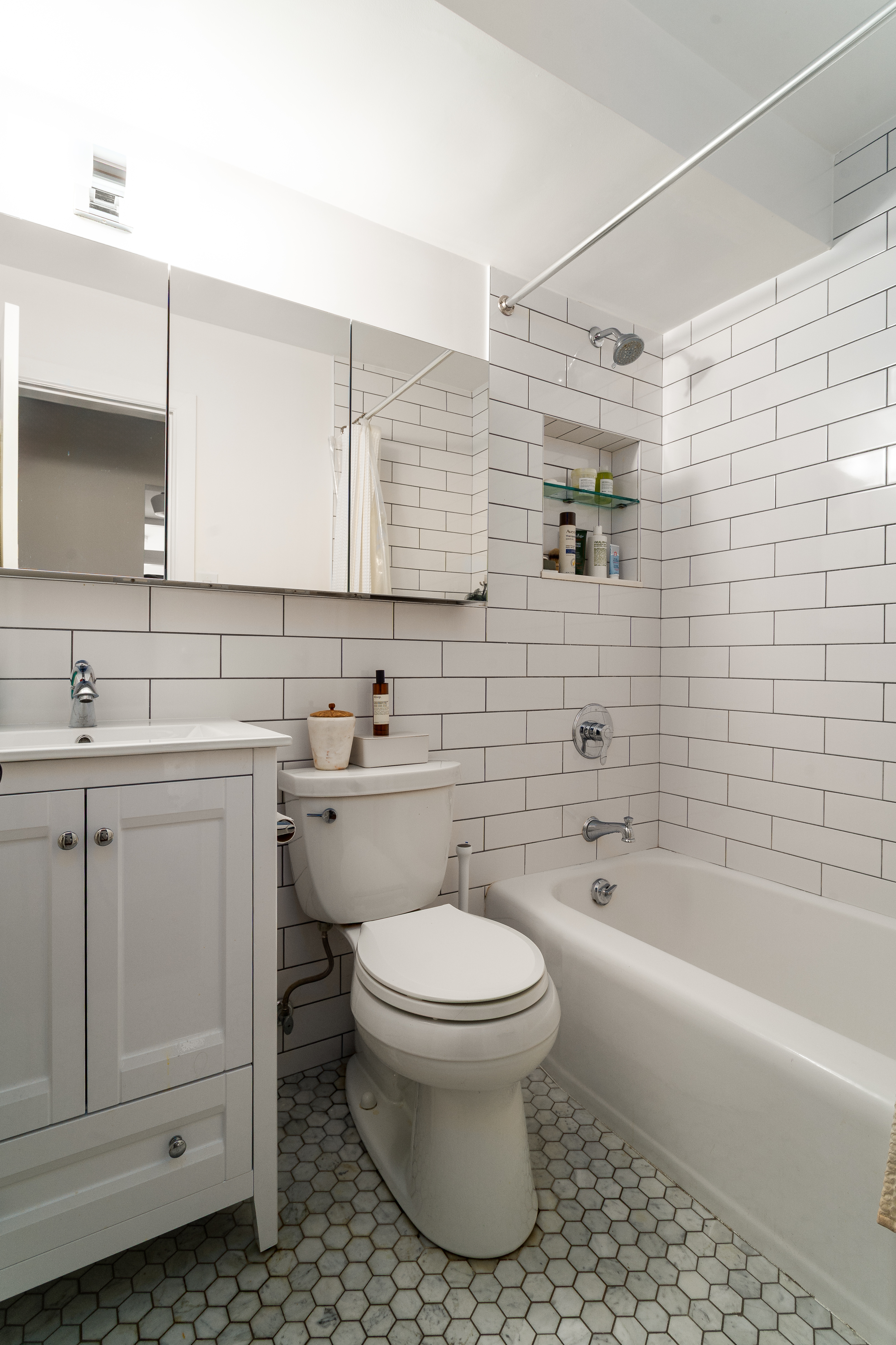 191 Willoughby Street, Unit 12J Brooklyn, NY 11201 - Photo 12 of 19 a bathroom with a sink toilet and shower