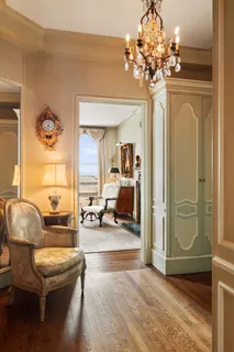 a living room with furniture and a chandelier