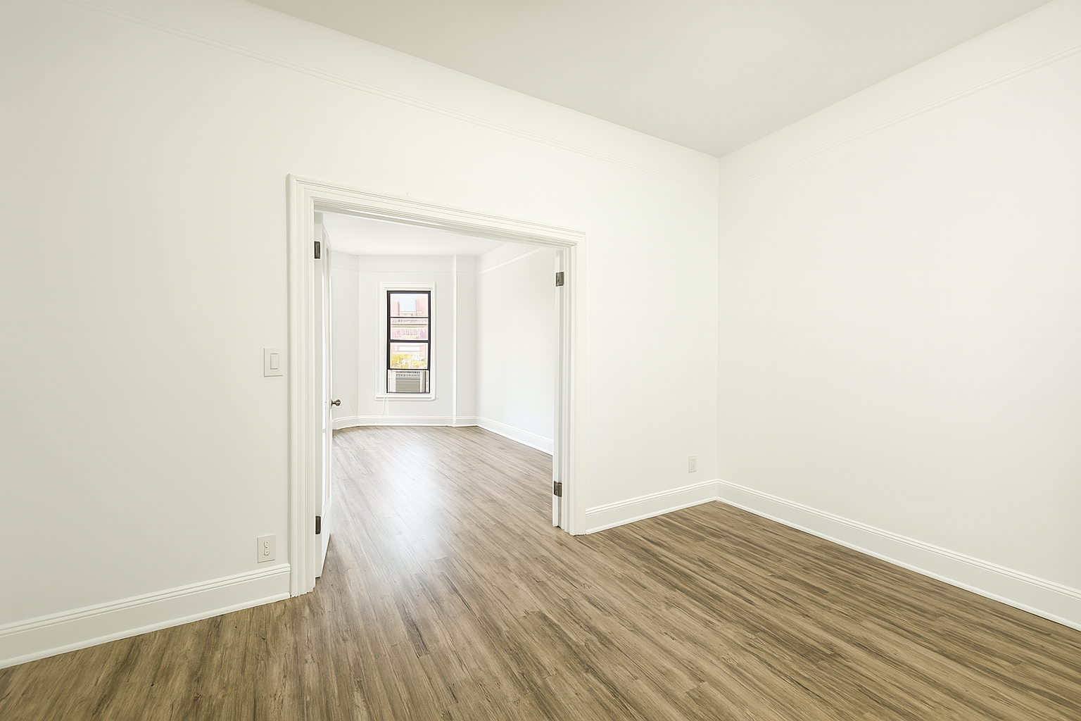 164 West 128th Street, Unit 4B Manhattan, NY 10027 - Photo 5 of 7 a view of a room with wooden floor and white walls