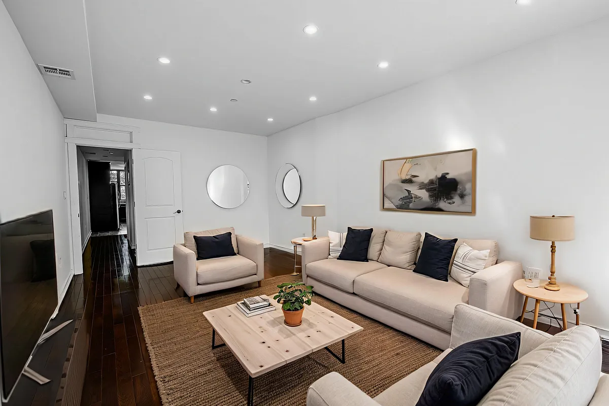 877 Greene Avenue, Unit 2 Brooklyn, NY 11221 - Photo 2 of 13 a living room with furniture and a flat screen tv