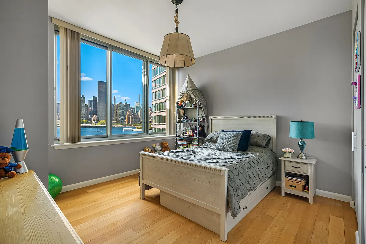 46-30 Center Boulevard, Unit 710 Queens, NY 11109 - Photo 10 of 25 a bedroom with a bed and a window