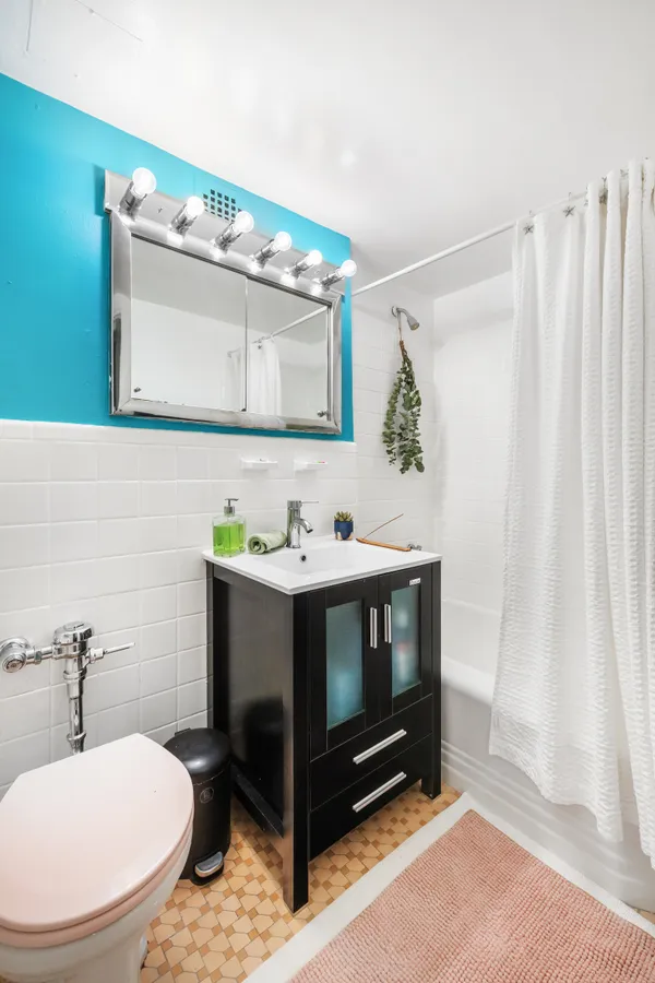 a bathroom with a sink toilet and mirror
