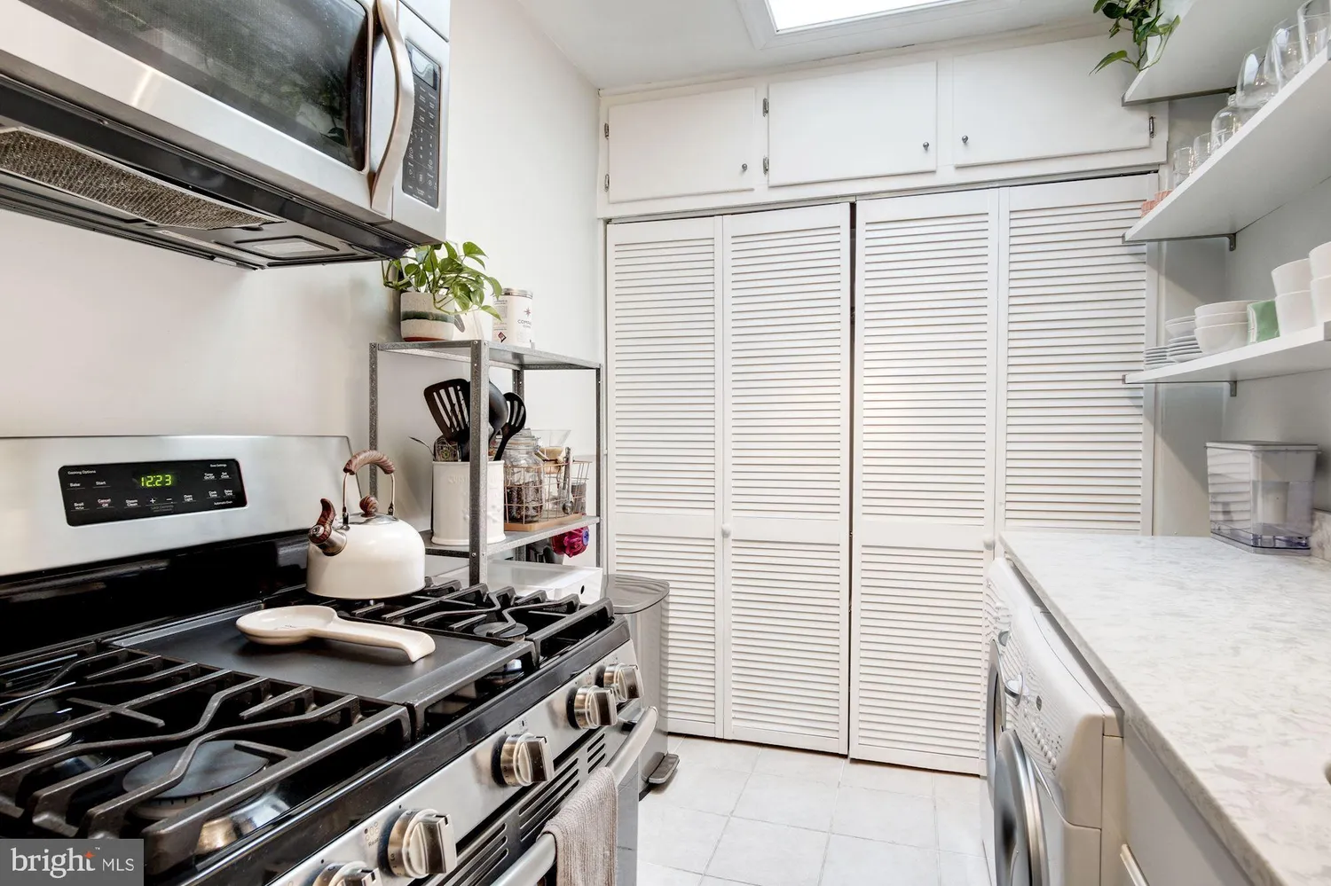 a kitchen with a sink appliances and cabinets