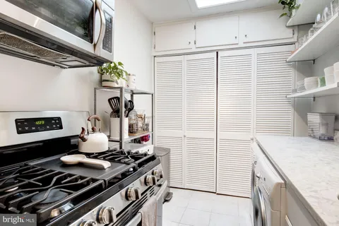 a kitchen with a sink appliances and cabinets