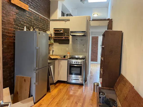 a kitchen with a refrigerator and a stove