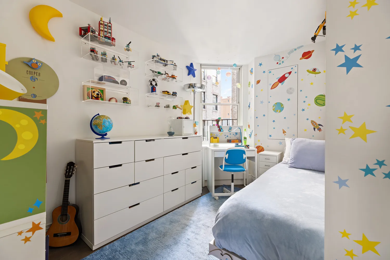 a bedroom with a bed and a window