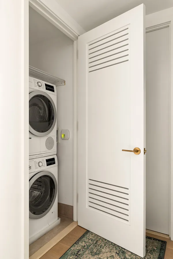 a view of a bedroom with washer and dryer