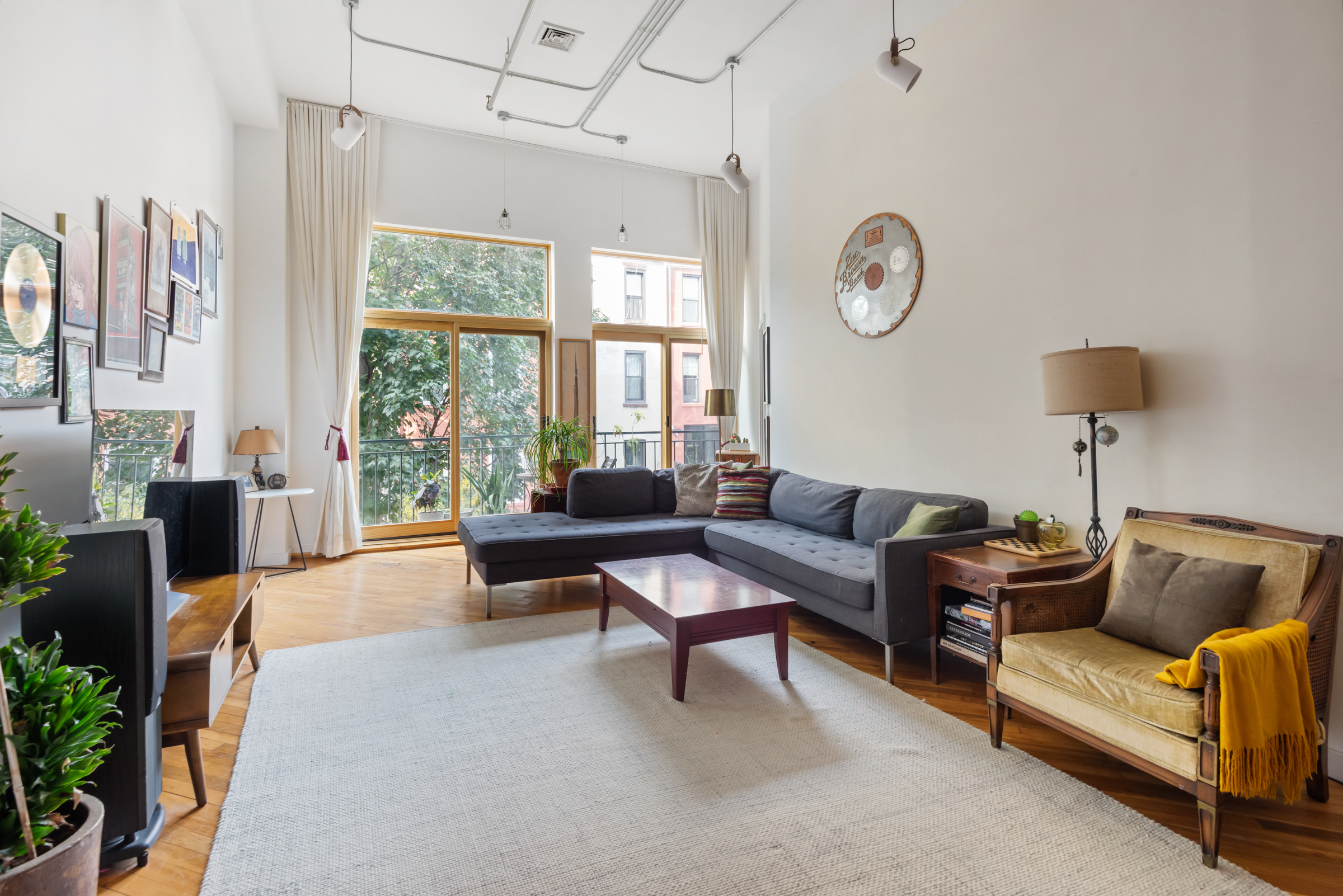 105 Lexington Avenue, Unit 2G Brooklyn, NY 11238 - Photo 3 of 17 a living room with furniture a rug a lamp and a large window