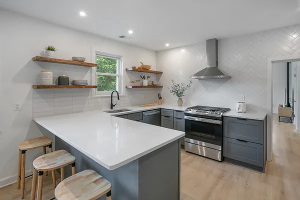 a kitchen with a stove a sink and a refrigerator