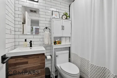 a bathroom with a sink toilet and mirror