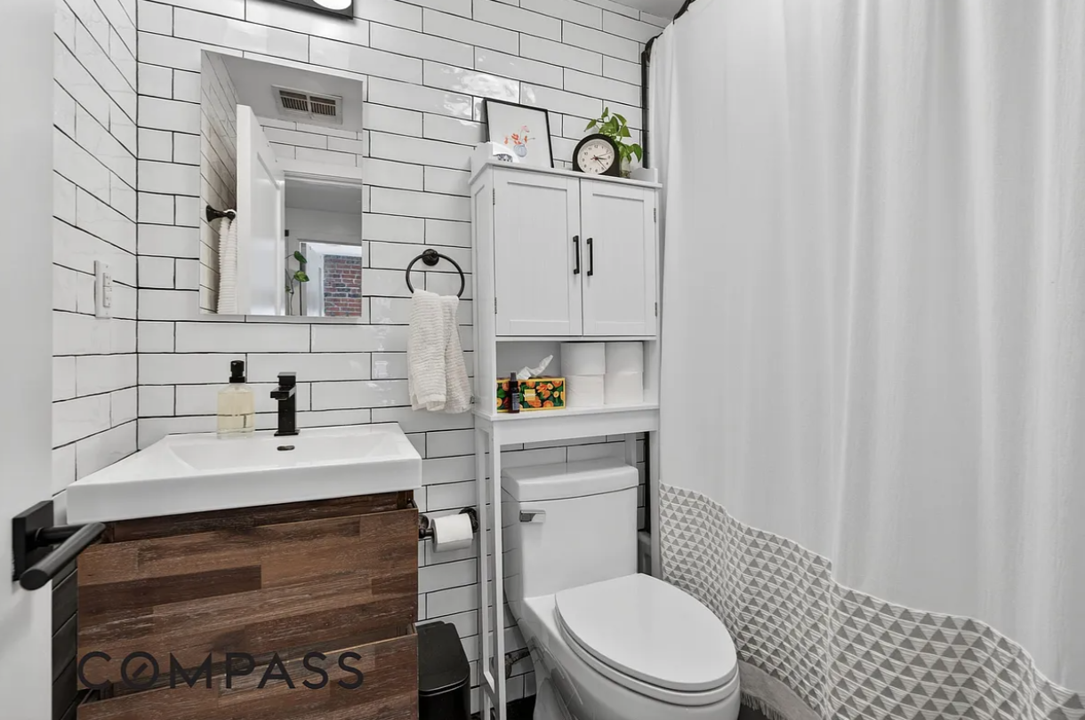923 Bedford Avenue, Unit 4F Brooklyn, NY 11205 - Photo 7 of 10 a bathroom with a sink toilet and mirror