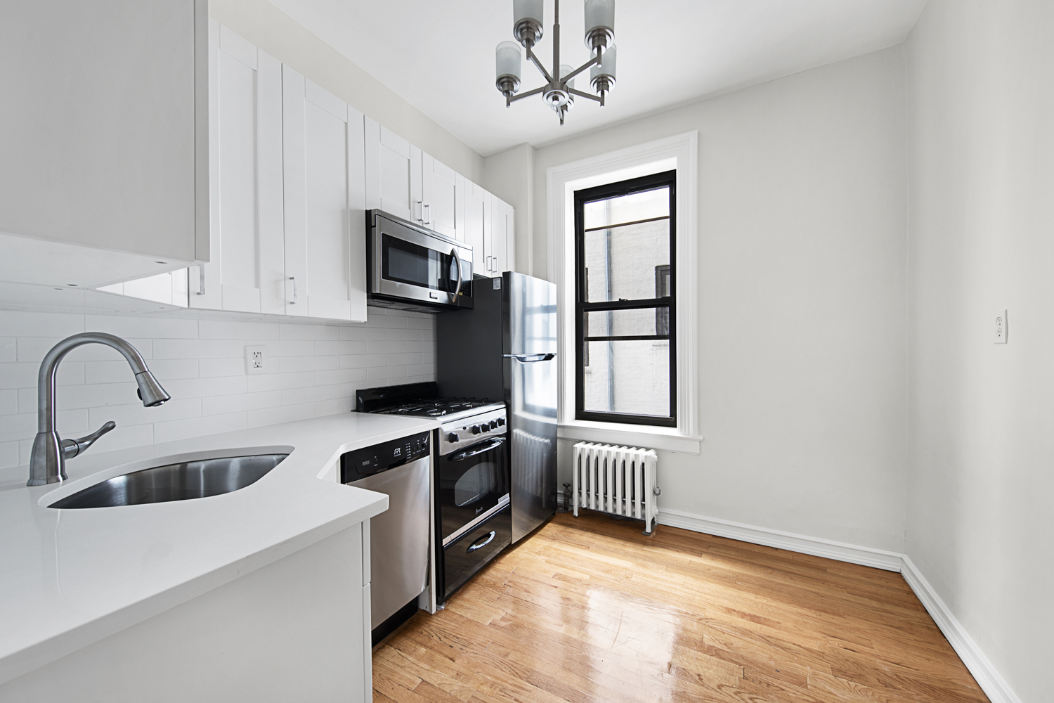 408 8th Avenue, Unit 2A Brooklyn, NY 11215 - Photo 2 of 7 a kitchen with stainless steel appliances granite countertop a stove a sink and a microwave