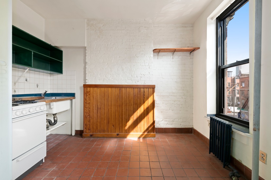 151 1st Avenue, Unit 3F Manhattan, NY 10003 - Photo 6 of 9 a view of a kitchen with an empty space and a window