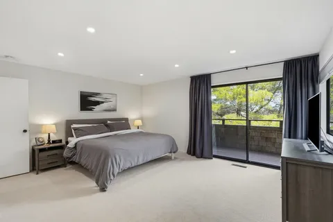 a bedroom with a balcony a bed and a television