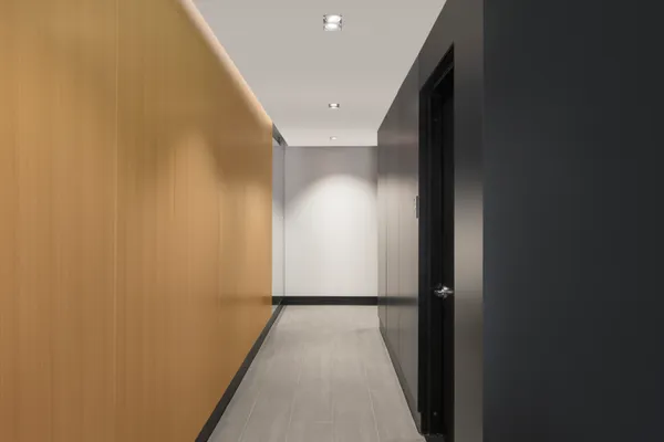 a view of a hallway with wooden floor