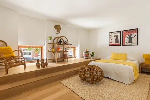 a bedroom with furniture and a large window