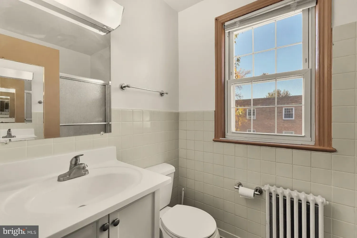 a bathroom with a sink toilet and mirror